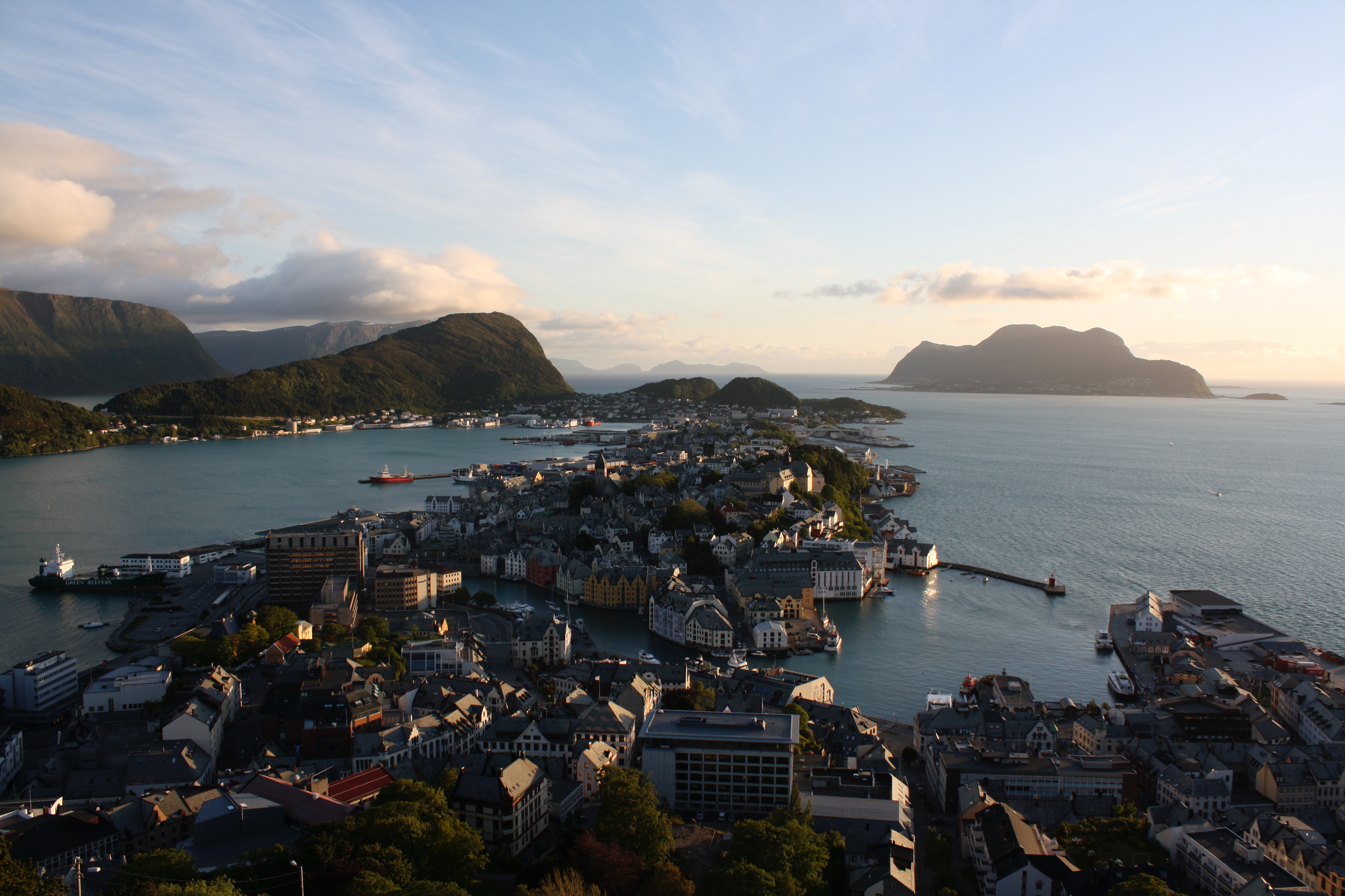 View of Ålesund, Norway, with water, mountains, and the town center.